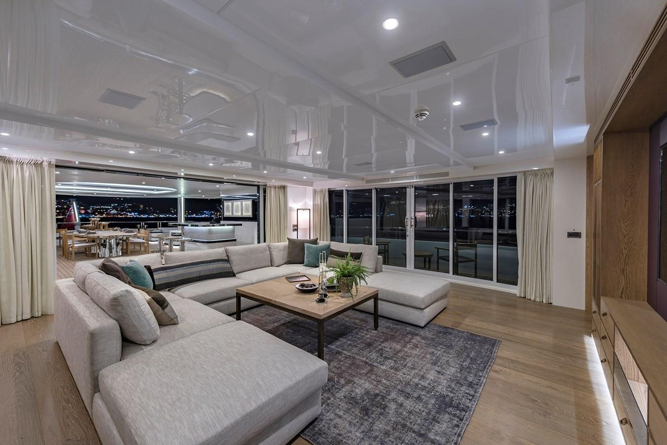 a living room with a large window aboard LIQUID SKY Yacht for Sale