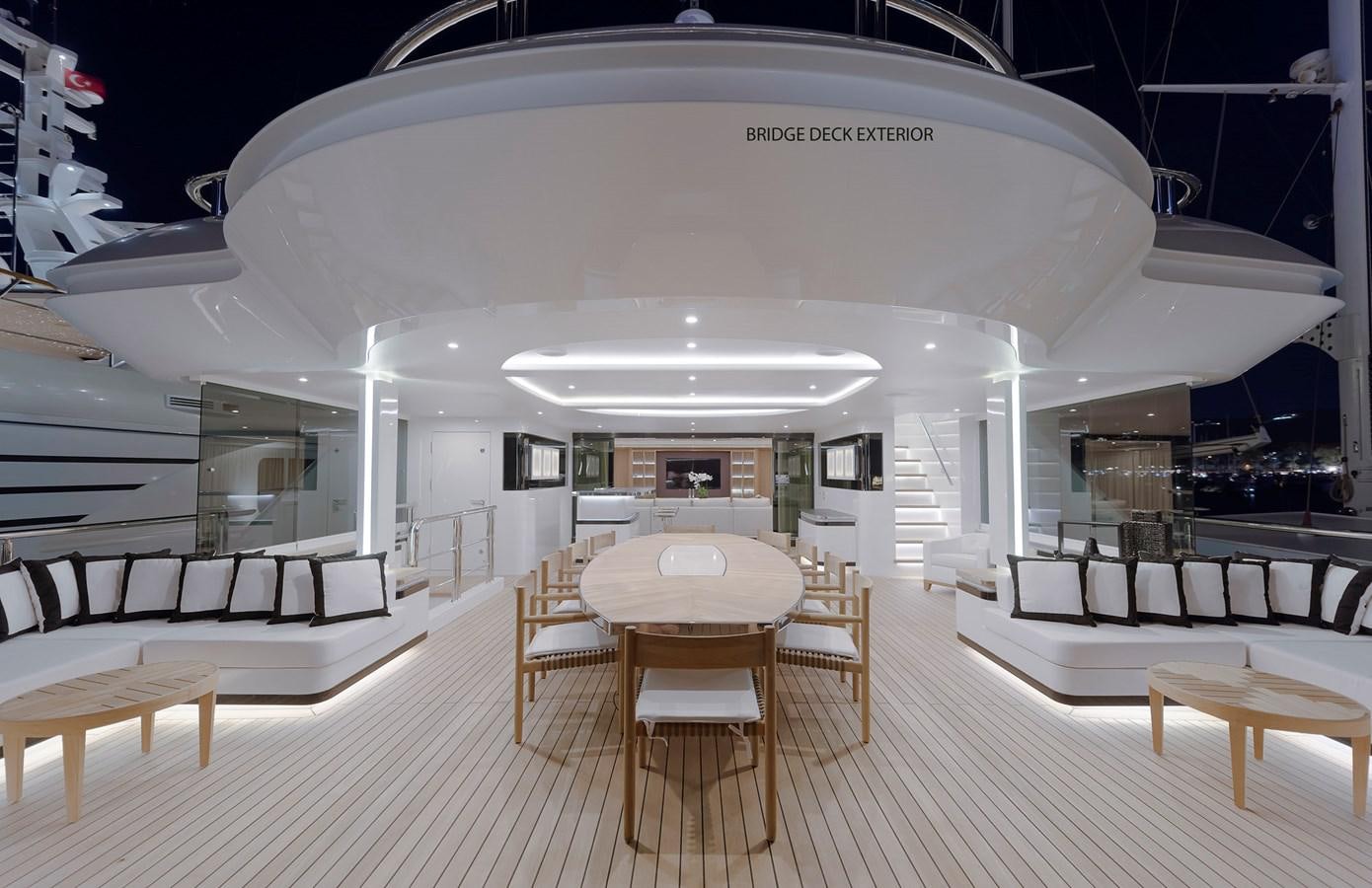 a room with tables and chairs aboard LIQUID SKY Yacht for Sale