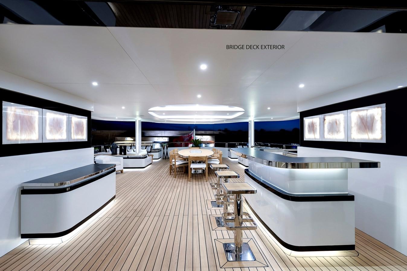 a room with a large screen and tables and chairs aboard LIQUID SKY Yacht for Sale