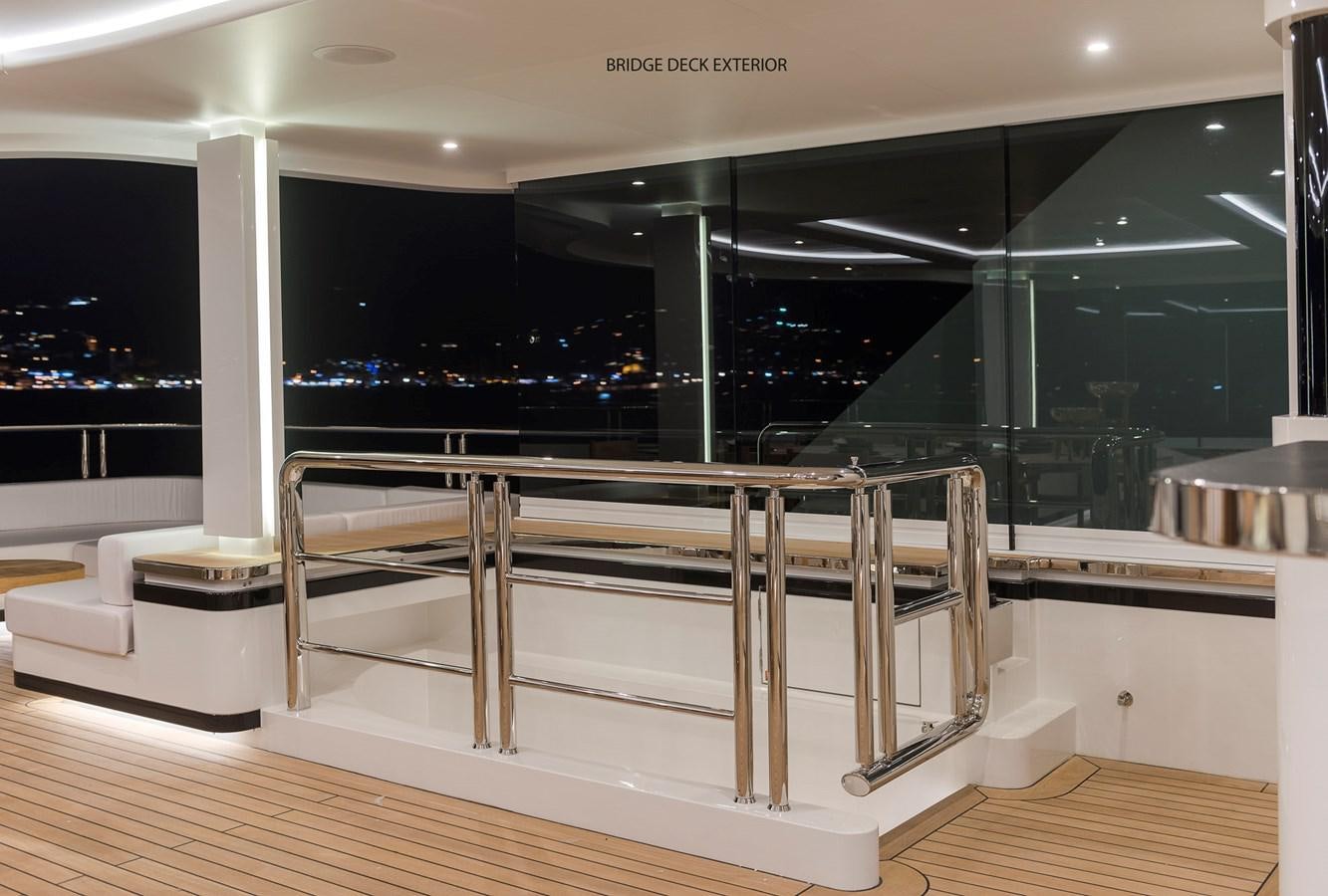 a room with a table and chairs aboard LIQUID SKY Yacht for Sale