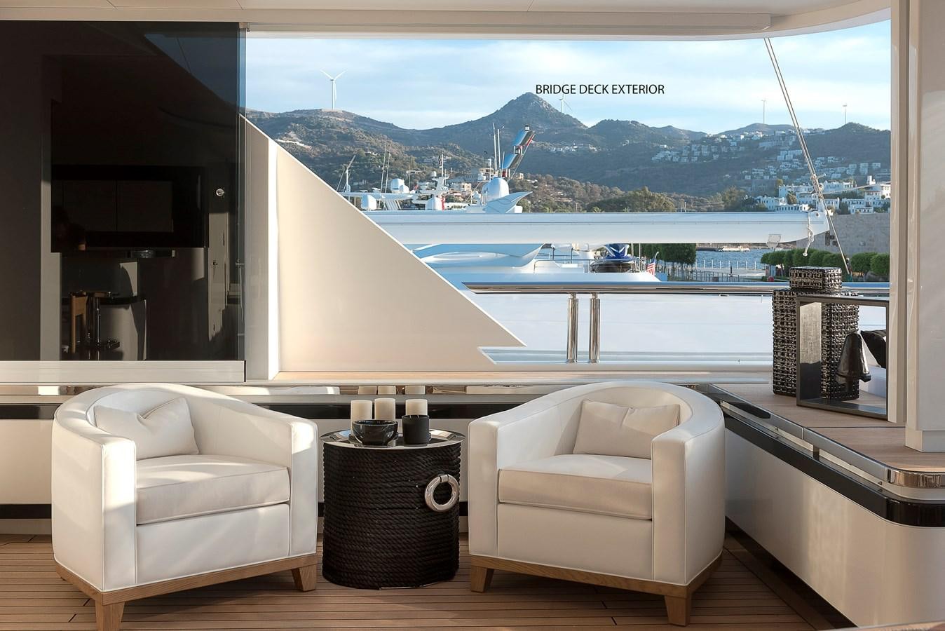 a room with a view of a body of water and boats aboard LIQUID SKY Yacht for Sale