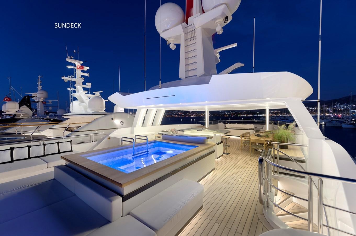 a large white building with a pool aboard LIQUID SKY Yacht for Sale