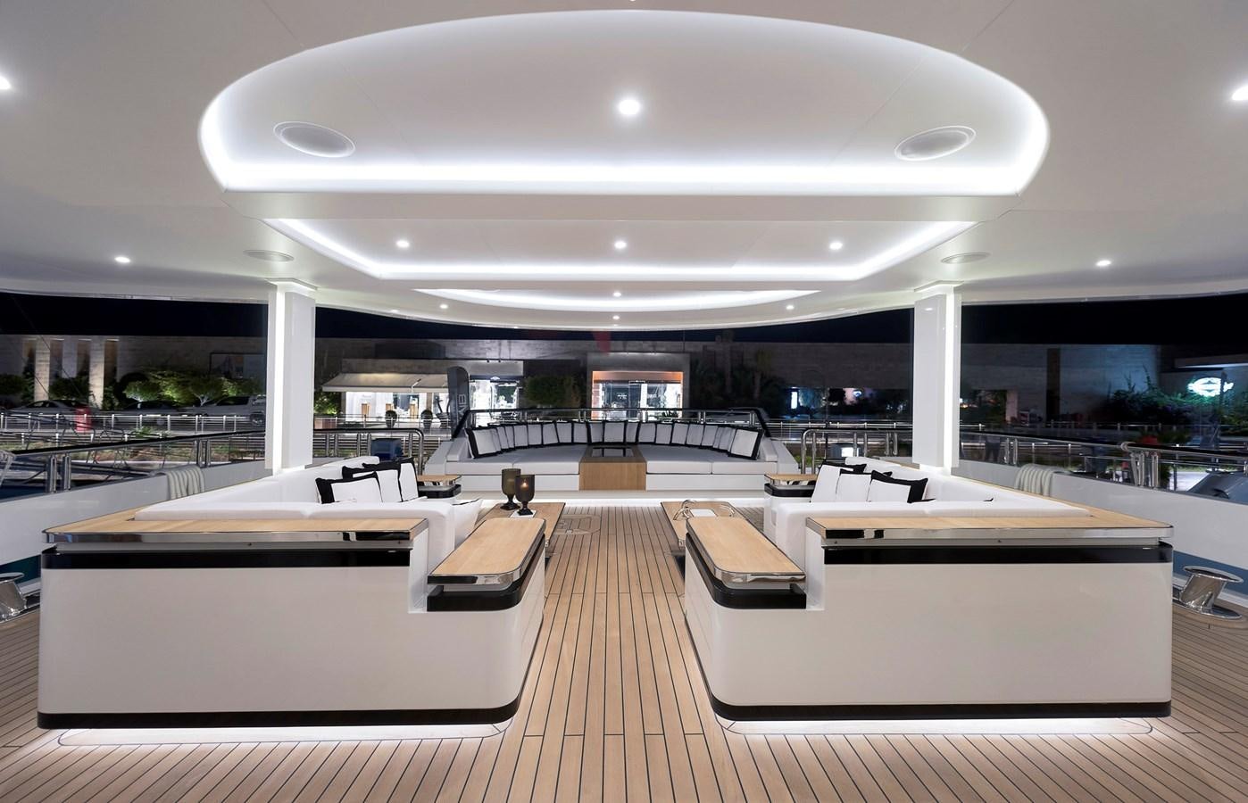 a room with tables and chairs aboard LIQUID SKY Yacht for Sale