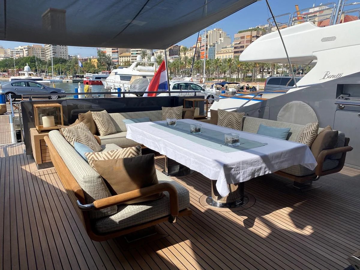 a couch and a table on a deck aboard ESCAPE Yacht for Sale