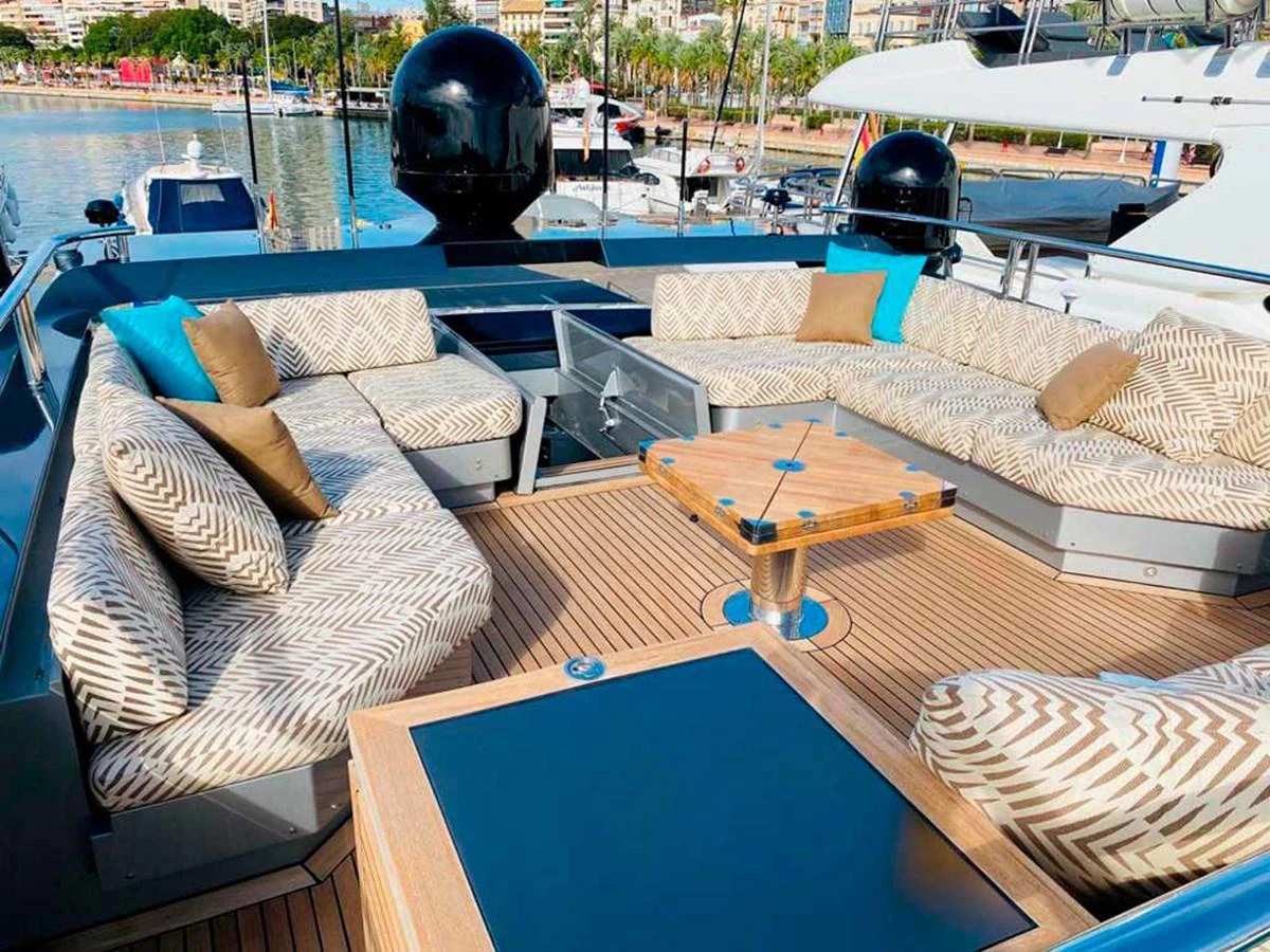 a deck with a table and chairs aboard ESCAPE Yacht for Sale
