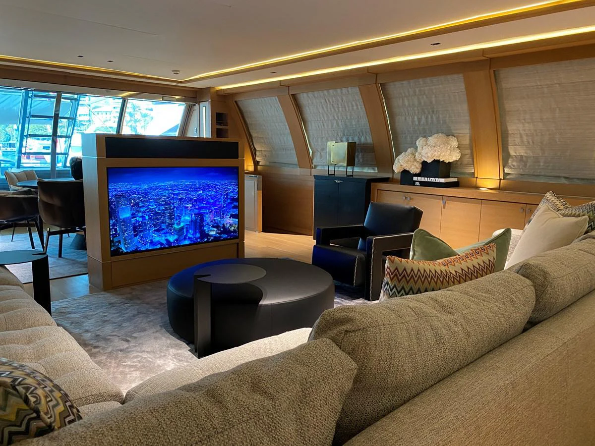 a living room with a large television aboard ESCAPE Yacht for Sale