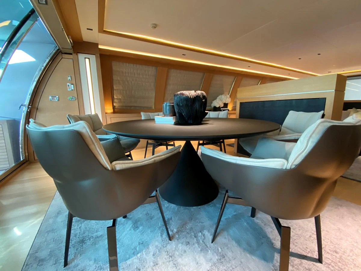 a table and chairs in a room aboard ESCAPE Yacht for Sale