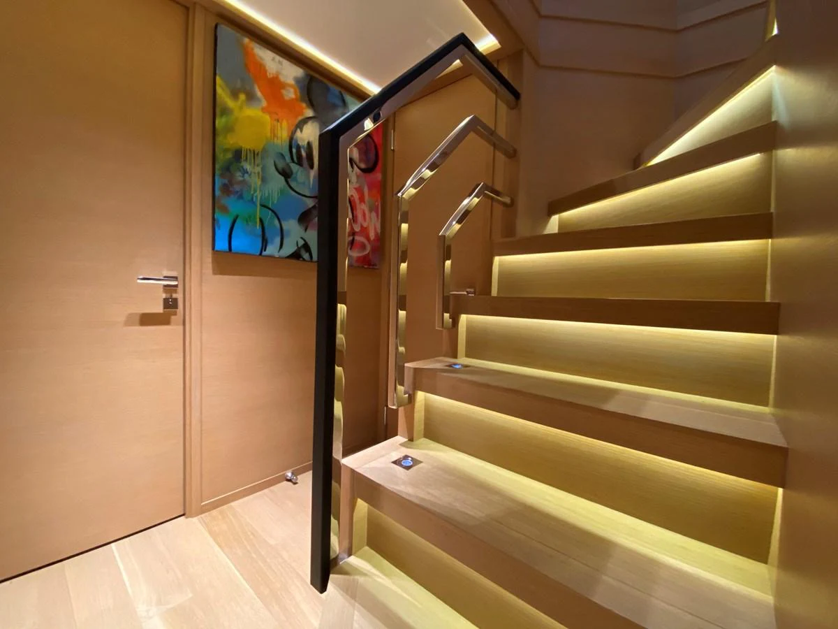 a staircase with a painting on the wall aboard ESCAPE Yacht for Sale
