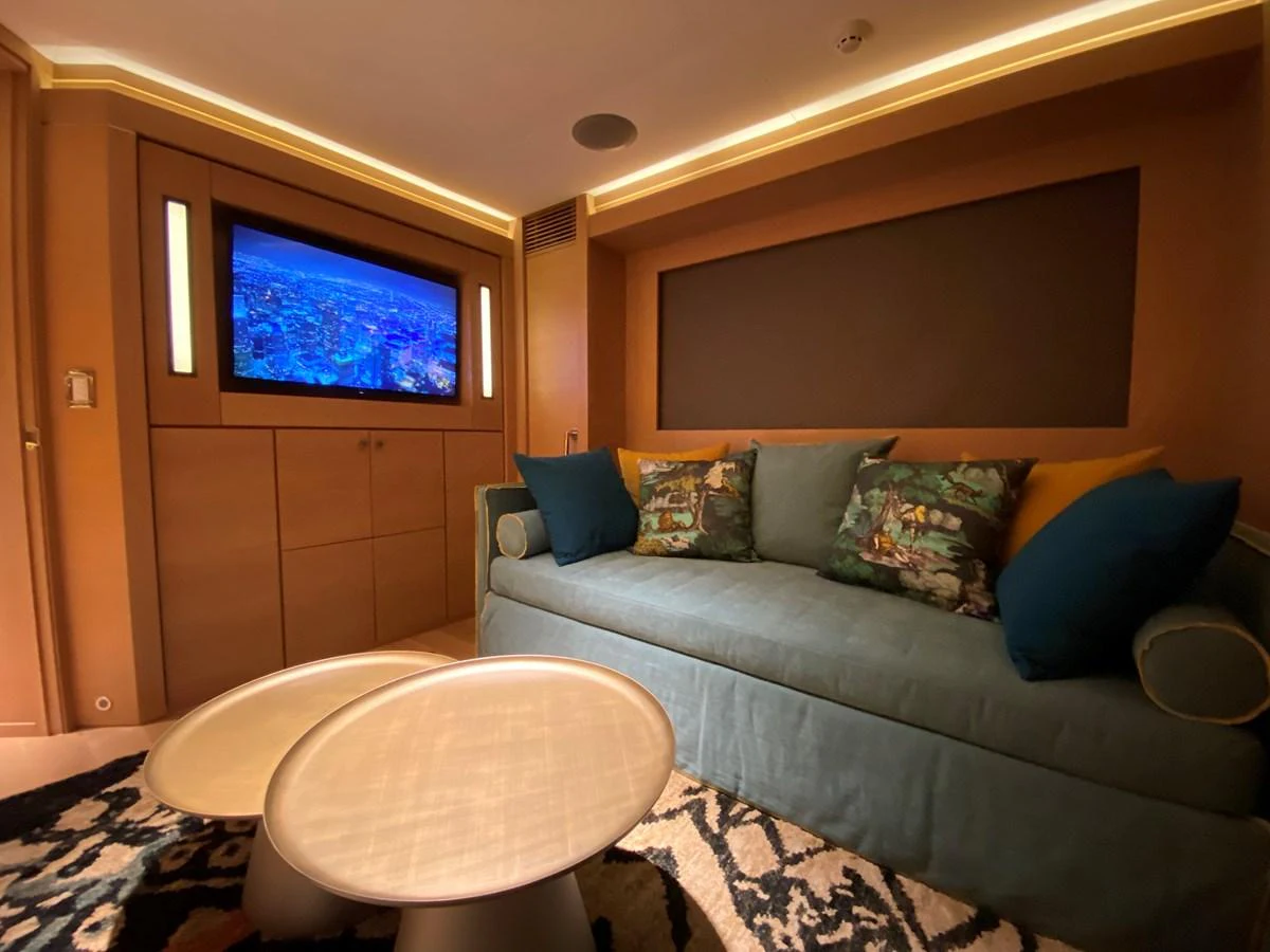 a living room with a couch and a television aboard ESCAPE Yacht for Sale