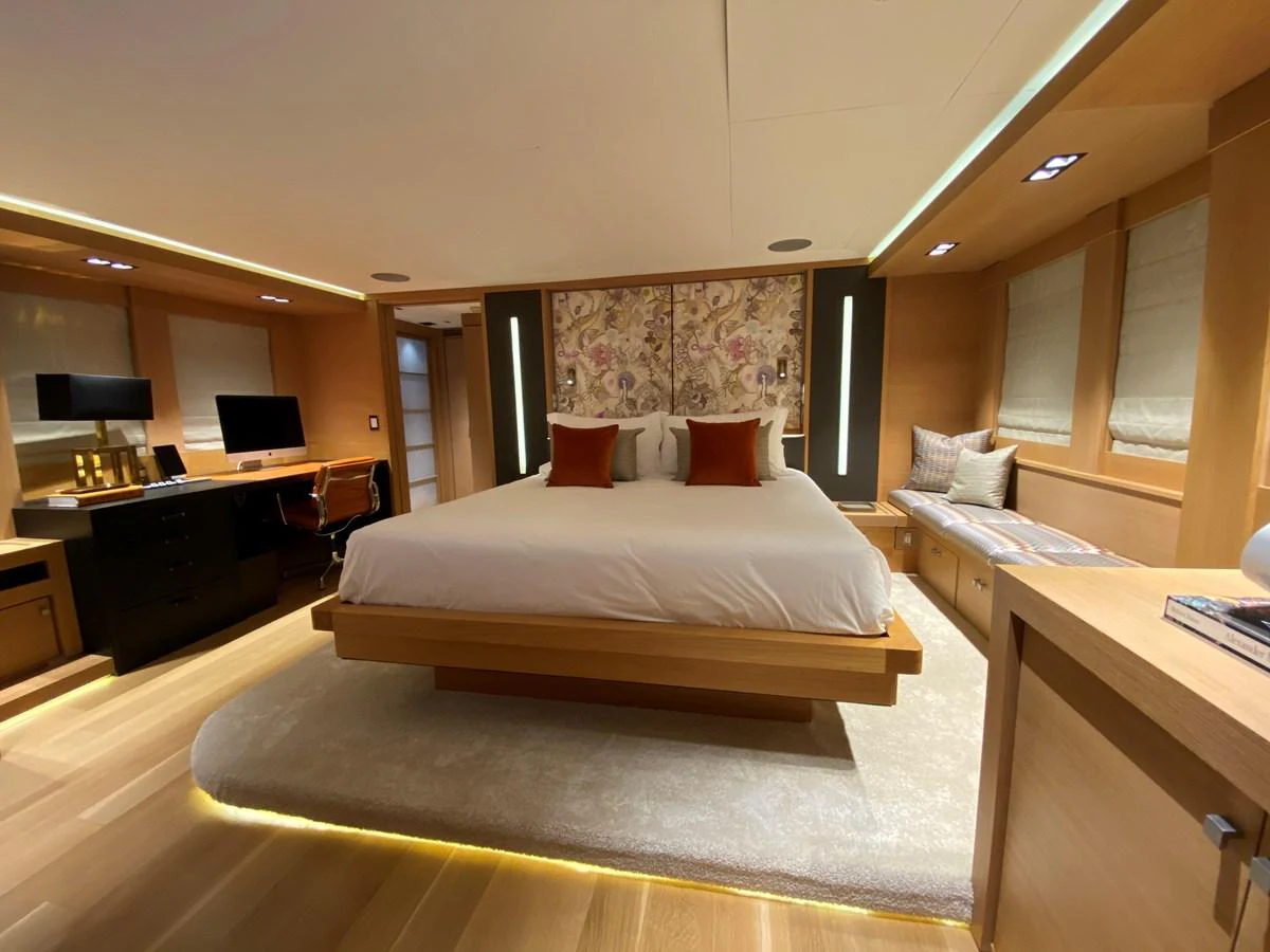 a hotel room with a bed and desk aboard ESCAPE Yacht for Sale