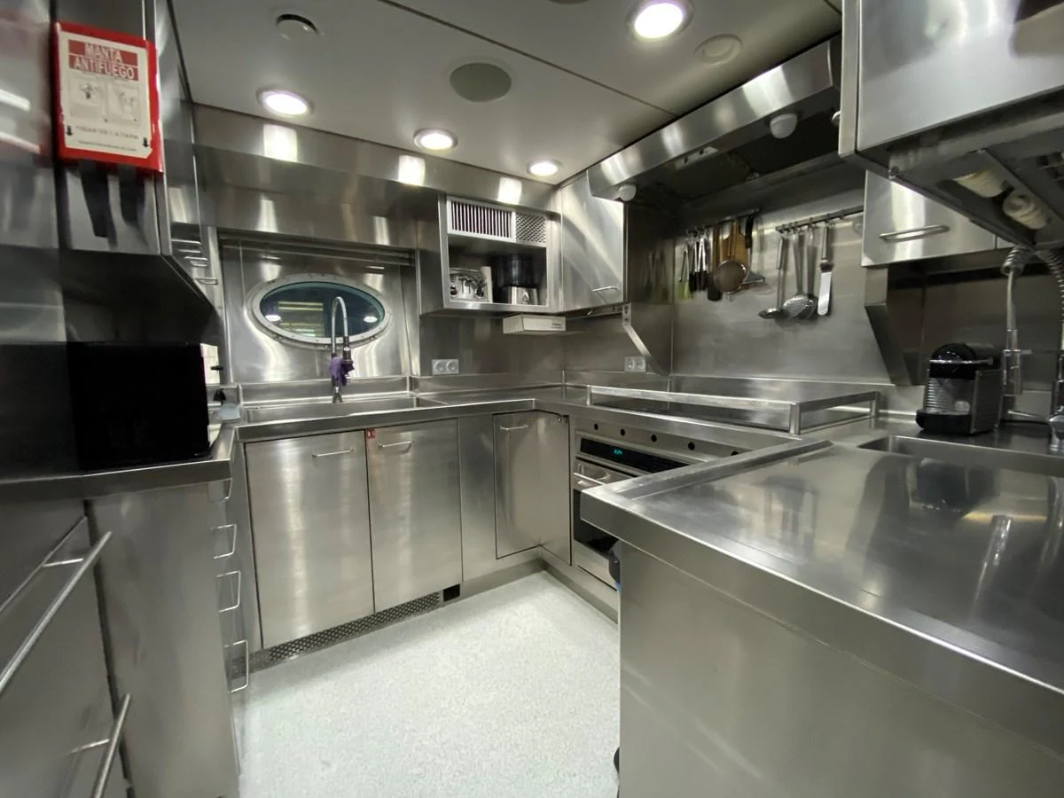 a kitchen with stainless steel appliances aboard ESCAPE Yacht for Sale