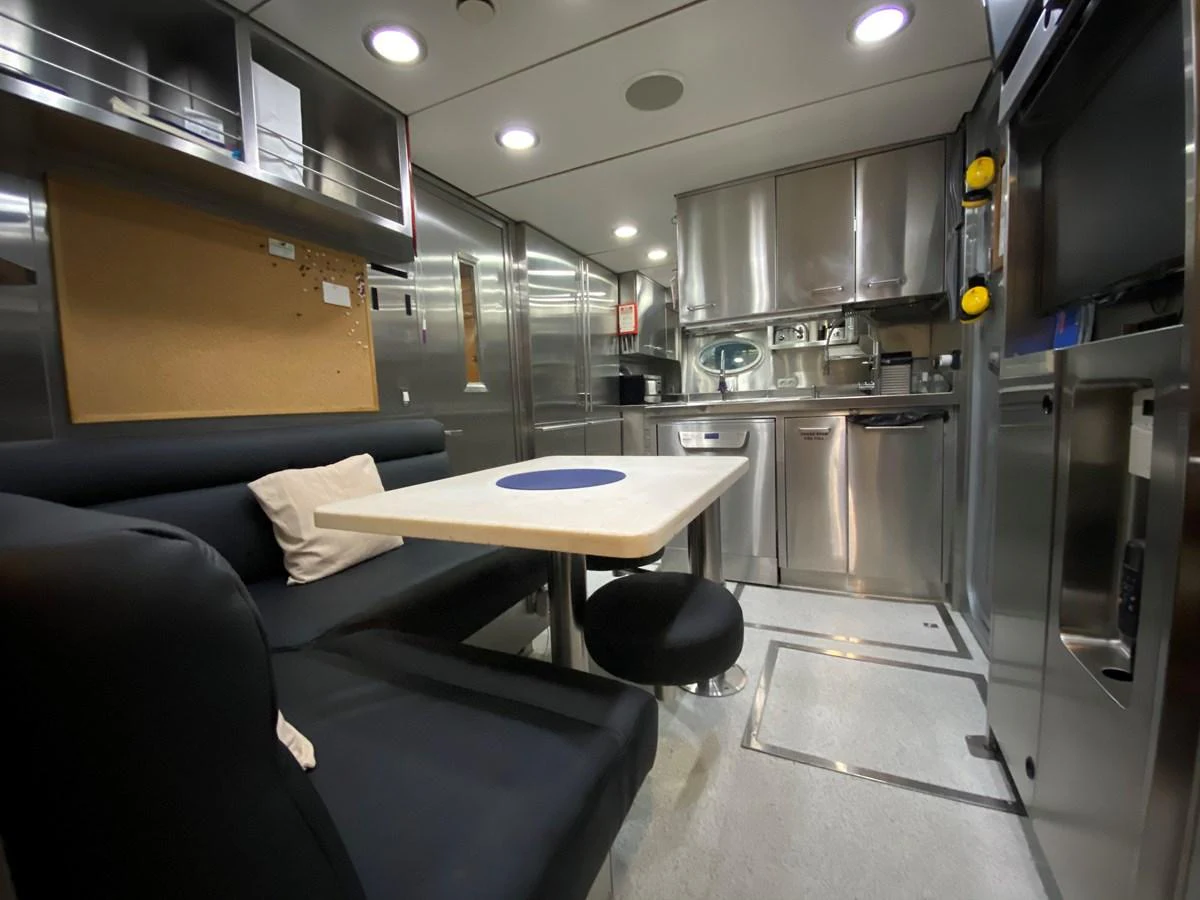 a room with a table and chairs aboard ESCAPE Yacht for Sale