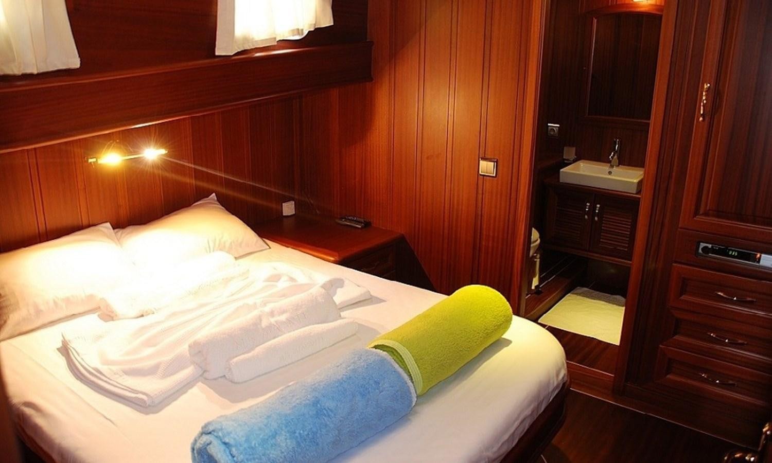 a room with a bed and a desk aboard ATALANTE Yacht for Sale