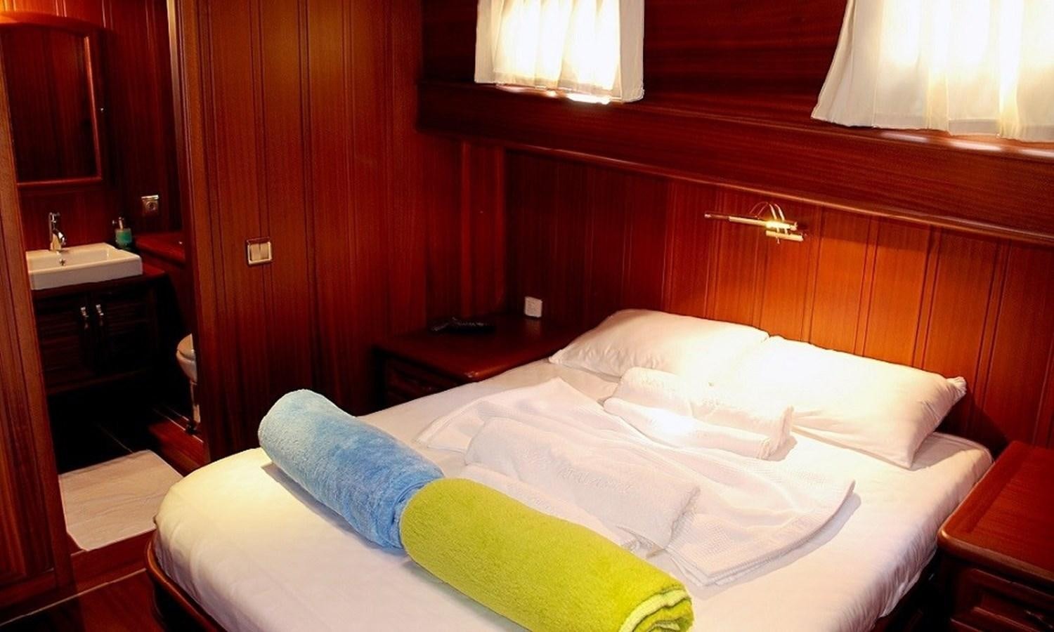 a room with a bed and a desk aboard ATALANTE Yacht for Sale