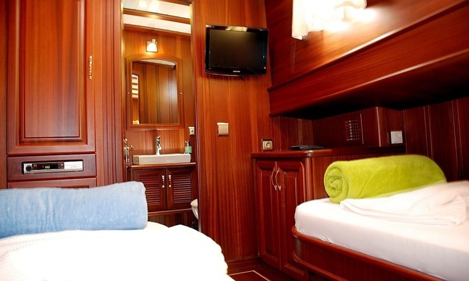 a room with a bed and a tv aboard ATALANTE Yacht for Sale