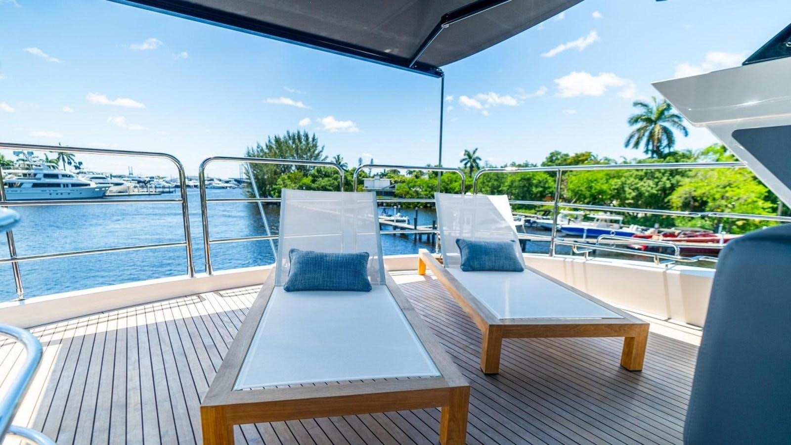 a deck with a view of the water and boats aboard 76 YACHT Yacht for Sale