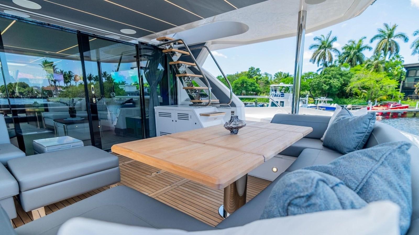 a room with a table and couches aboard 76 YACHT Yacht for Sale