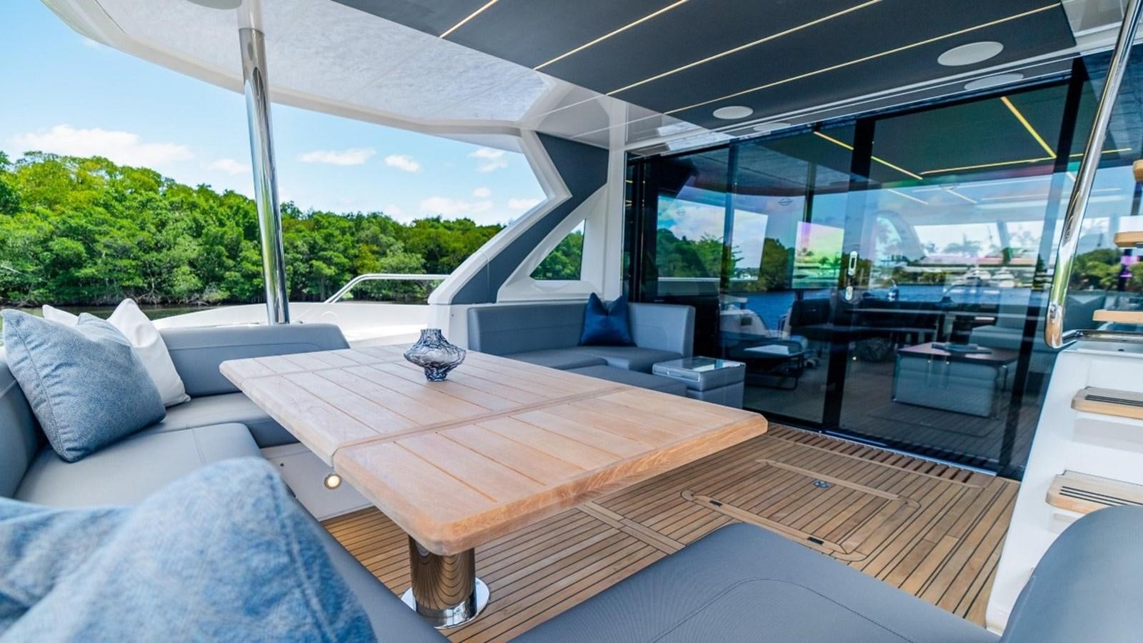 a room with a table and chairs aboard 76 YACHT Yacht for Sale