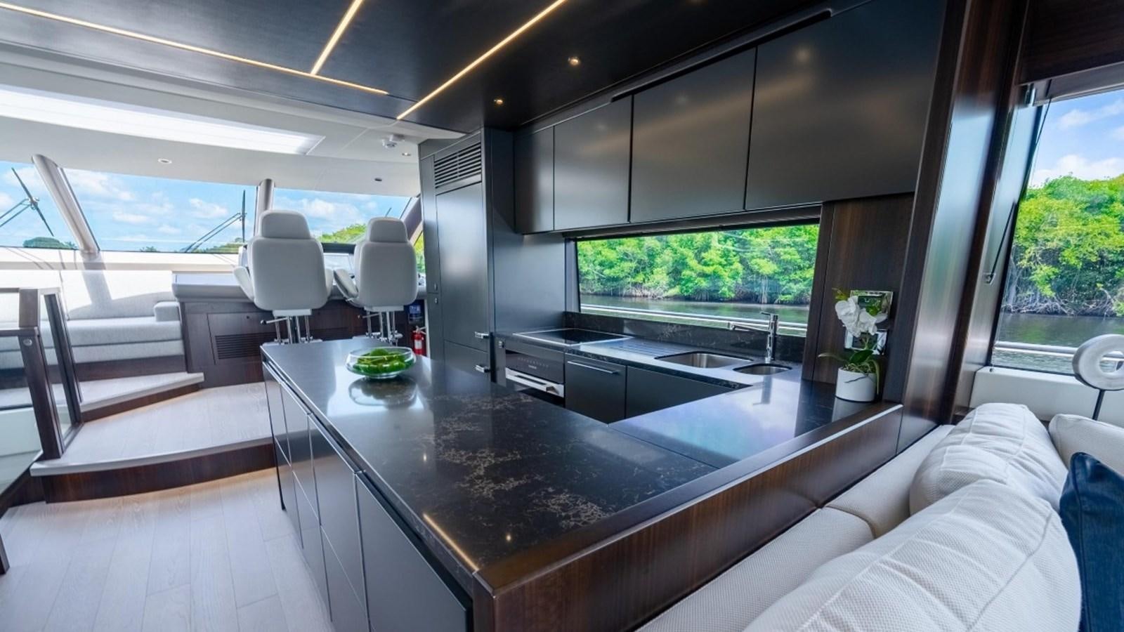 a modern looking kitchen with a large island aboard 76 YACHT Yacht for Sale