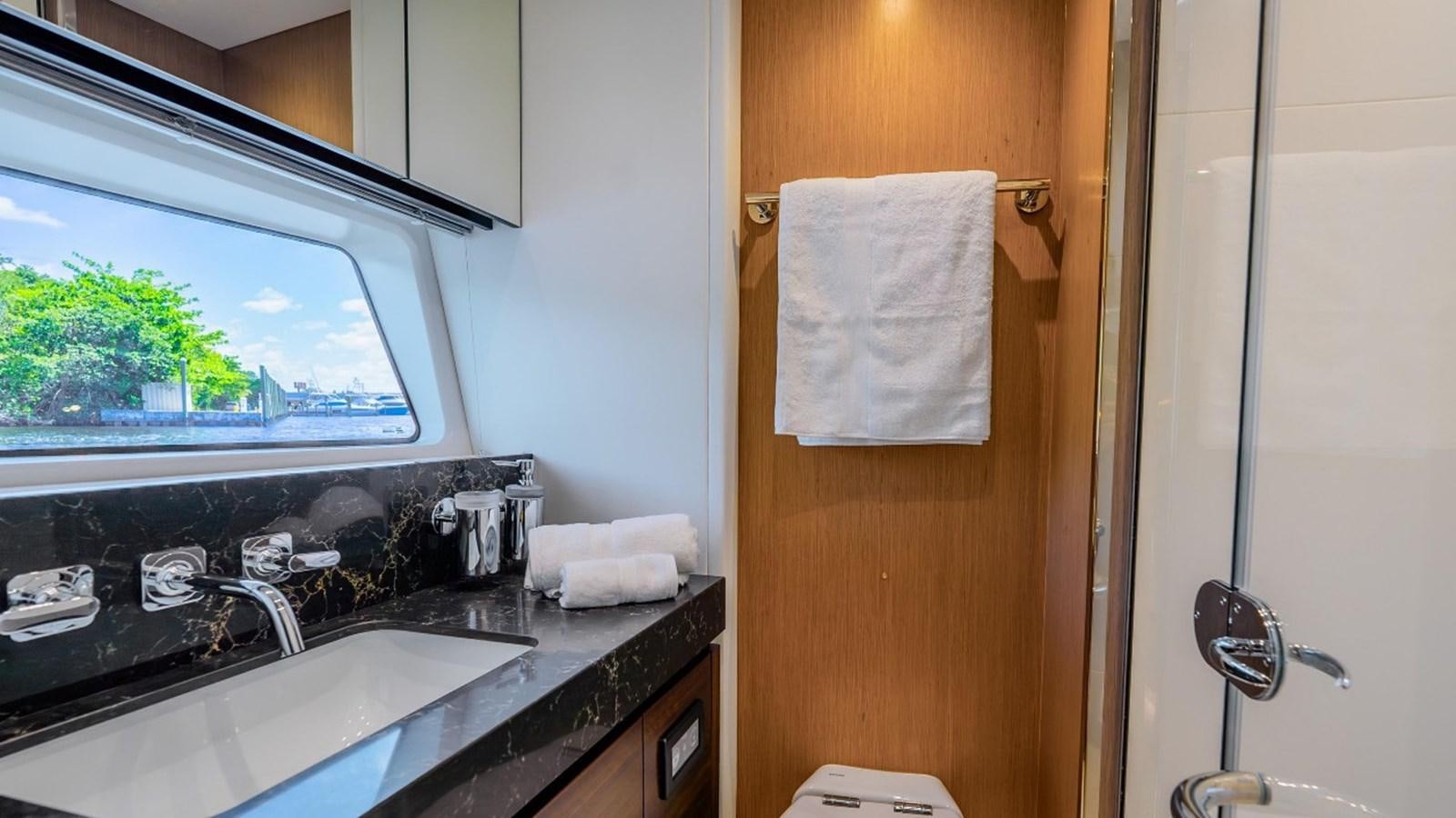 a bathroom with a sink and a window aboard 76 YACHT Yacht for Sale