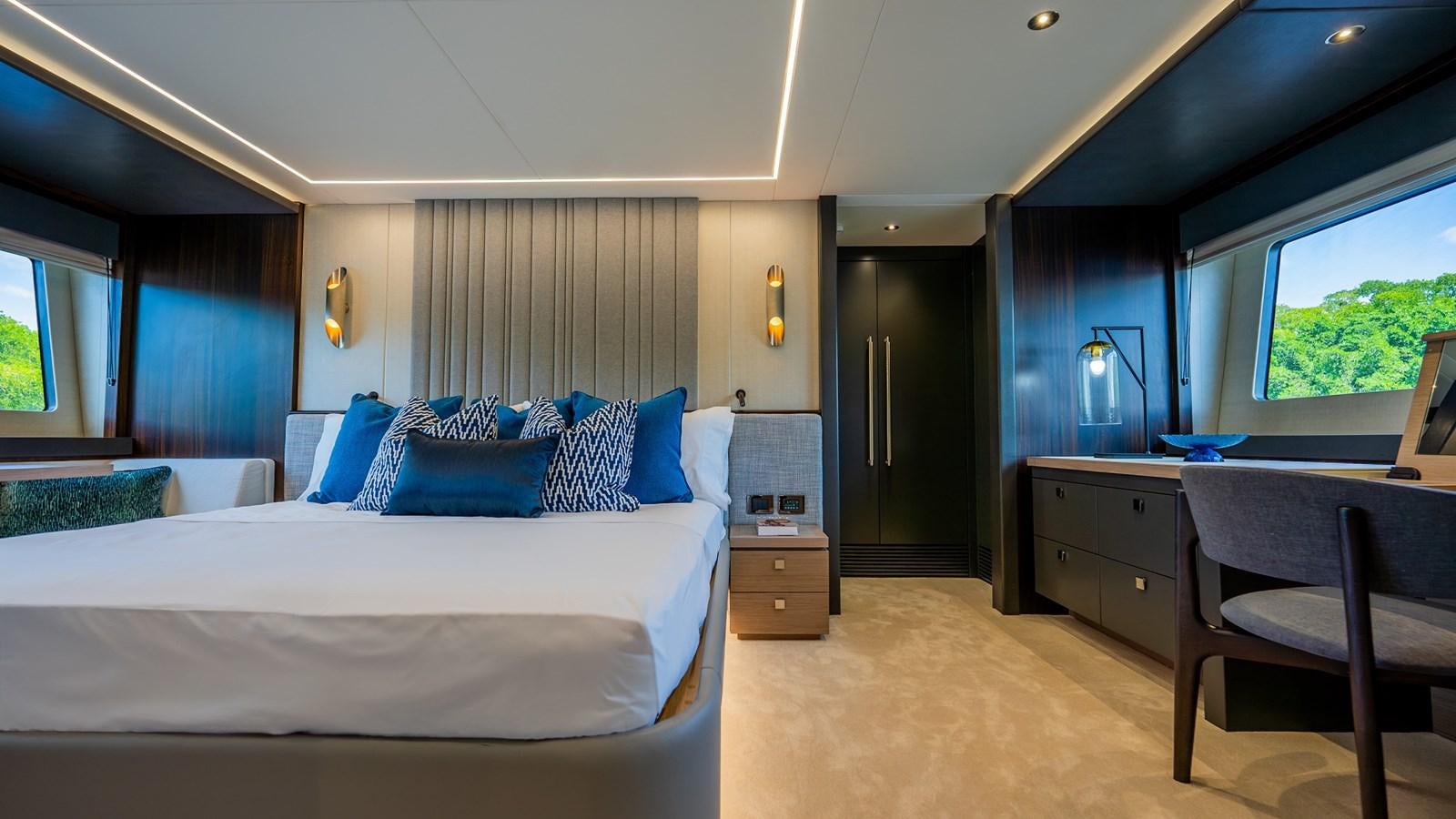 a bedroom with a bed and a desk aboard 76 YACHT Yacht for Sale