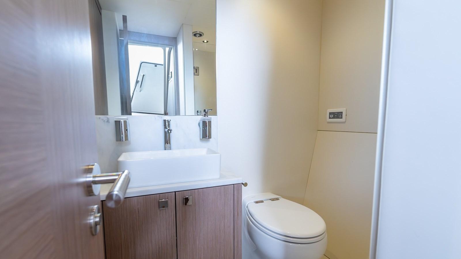 a bathroom with a sink and a toilet aboard 76 YACHT Yacht for Sale