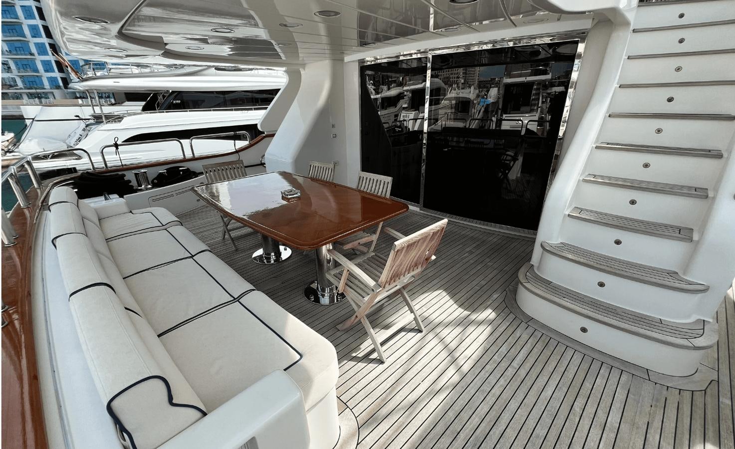 a room with a table chairs and a bench aboard 2008 BENETTI 100 Yacht for Sale