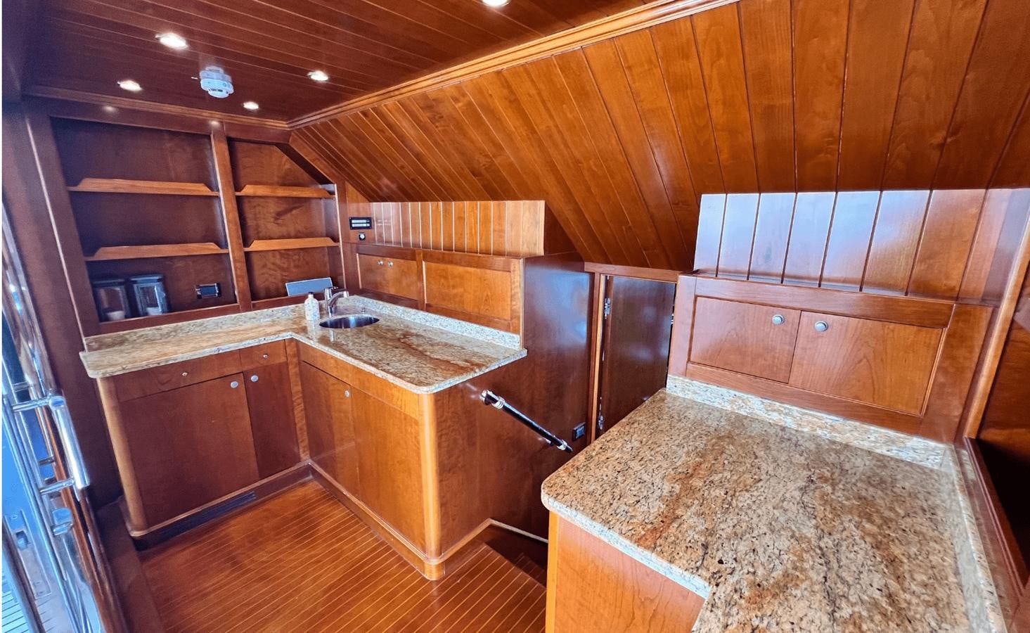 a large kitchen with wooden cabinets aboard 2008 BENETTI 100 Yacht for Sale