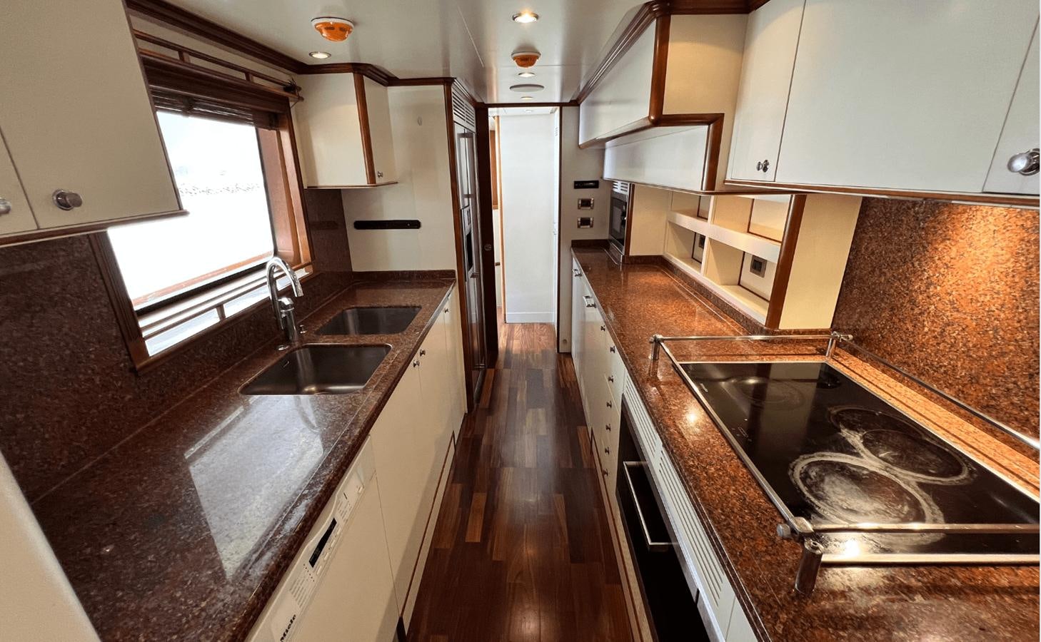a kitchen with a large island aboard 2008 BENETTI 100 Yacht for Sale