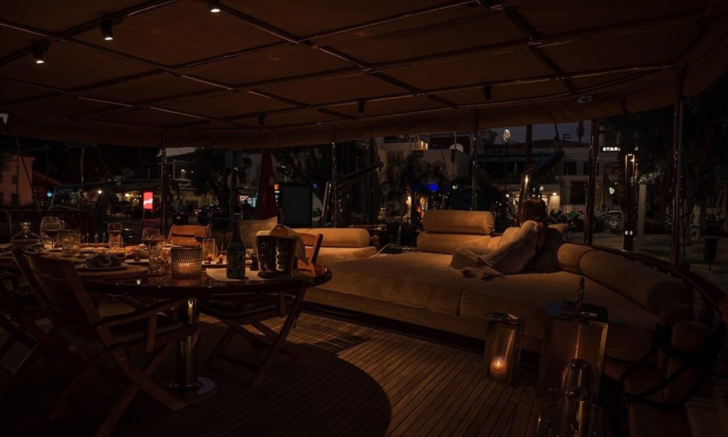 a large room with a couch and a table with food on it aboard CUSTOM MADE 30 M MOTORSAILOR Yacht for Sale