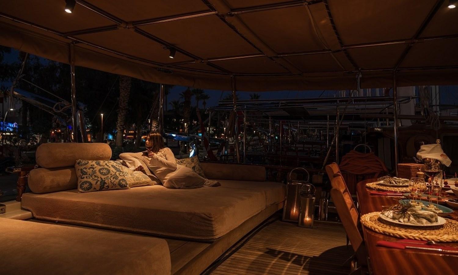 a person sitting on a couch aboard CUSTOM MADE 30 M MOTORSAILOR Yacht for Sale