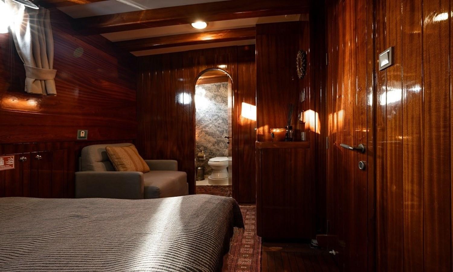 a bed and a couch in a room aboard CUSTOM MADE 30 M MOTORSAILOR Yacht for Sale