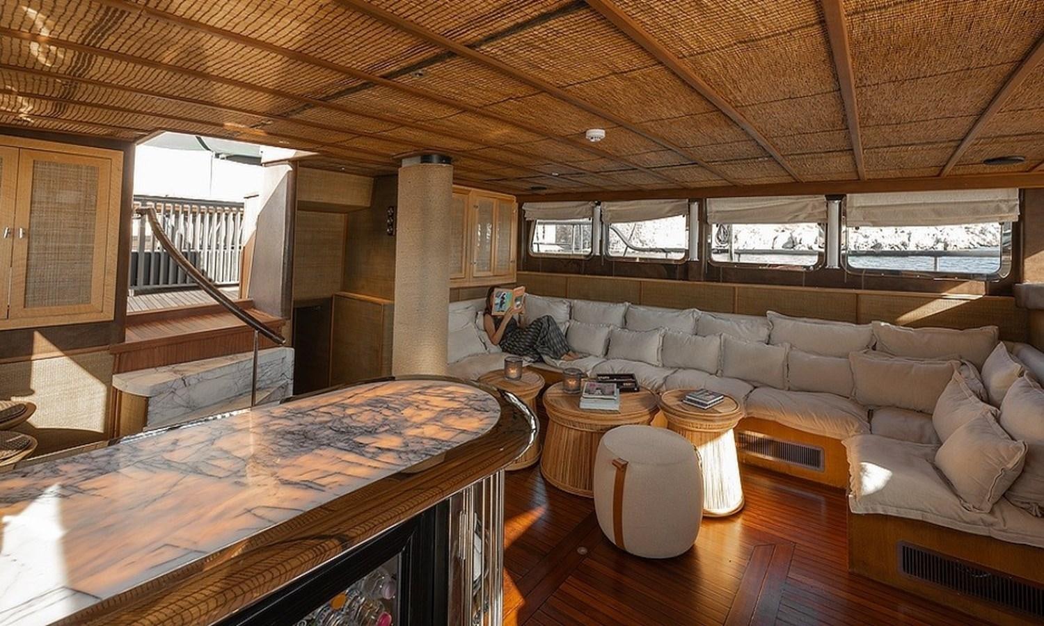 a living room with a couch and a table aboard CUSTOM MADE MOTORSAILOR Yacht for Sale