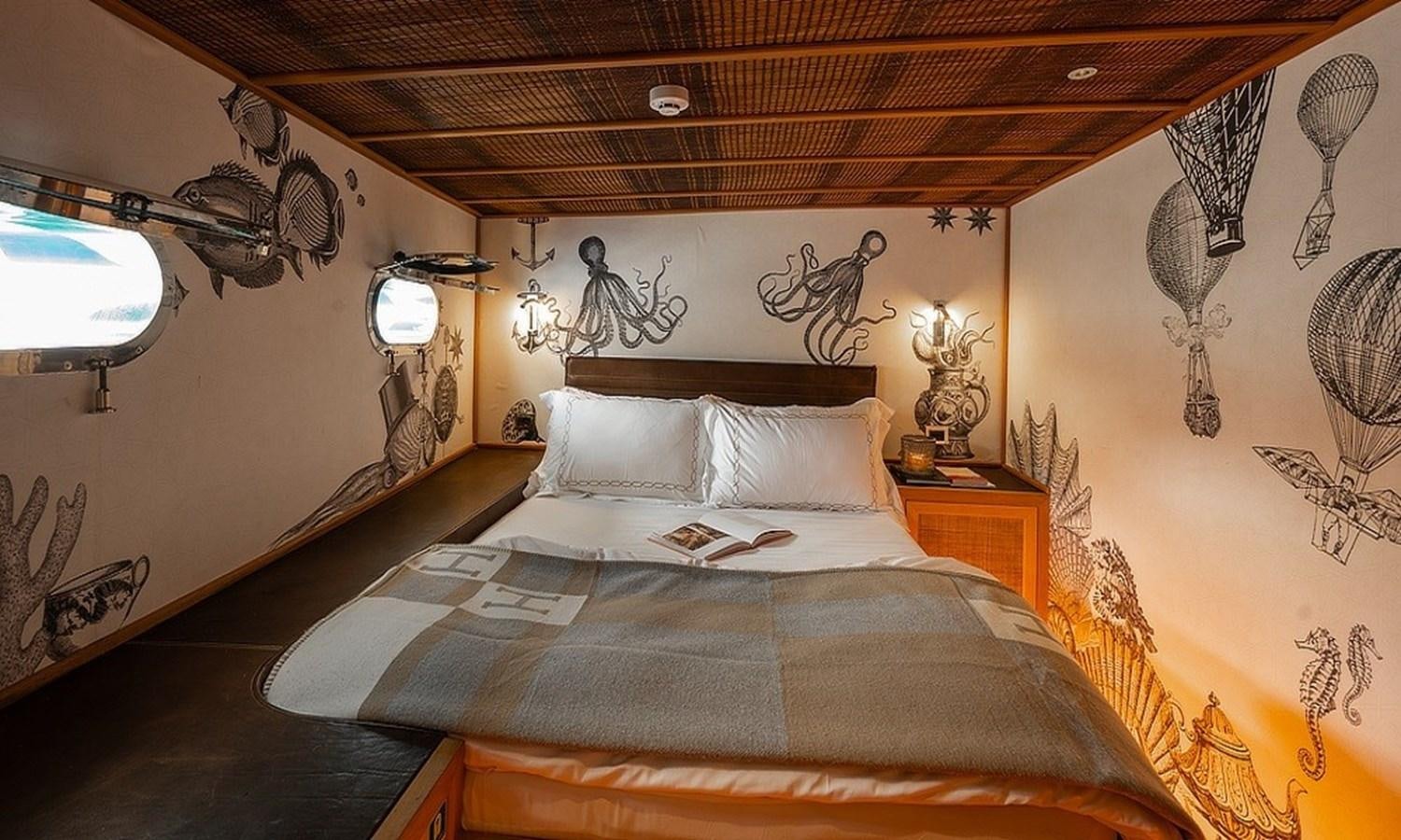 a bed with a large bed aboard CUSTOM MADE MOTORSAILOR Yacht for Sale