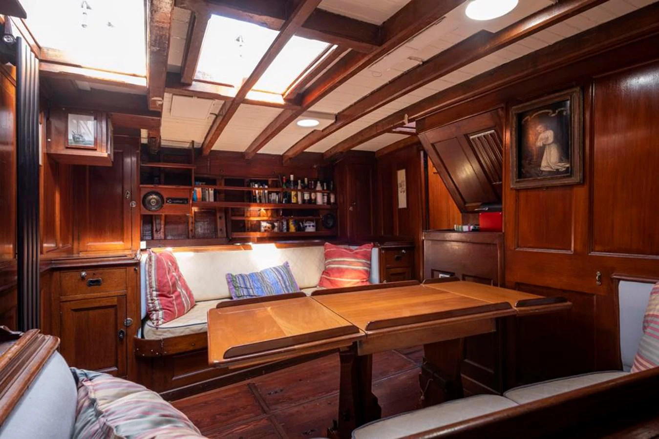 a room with wooden cabinets and a couch aboard JULIETTE Yacht for Sale