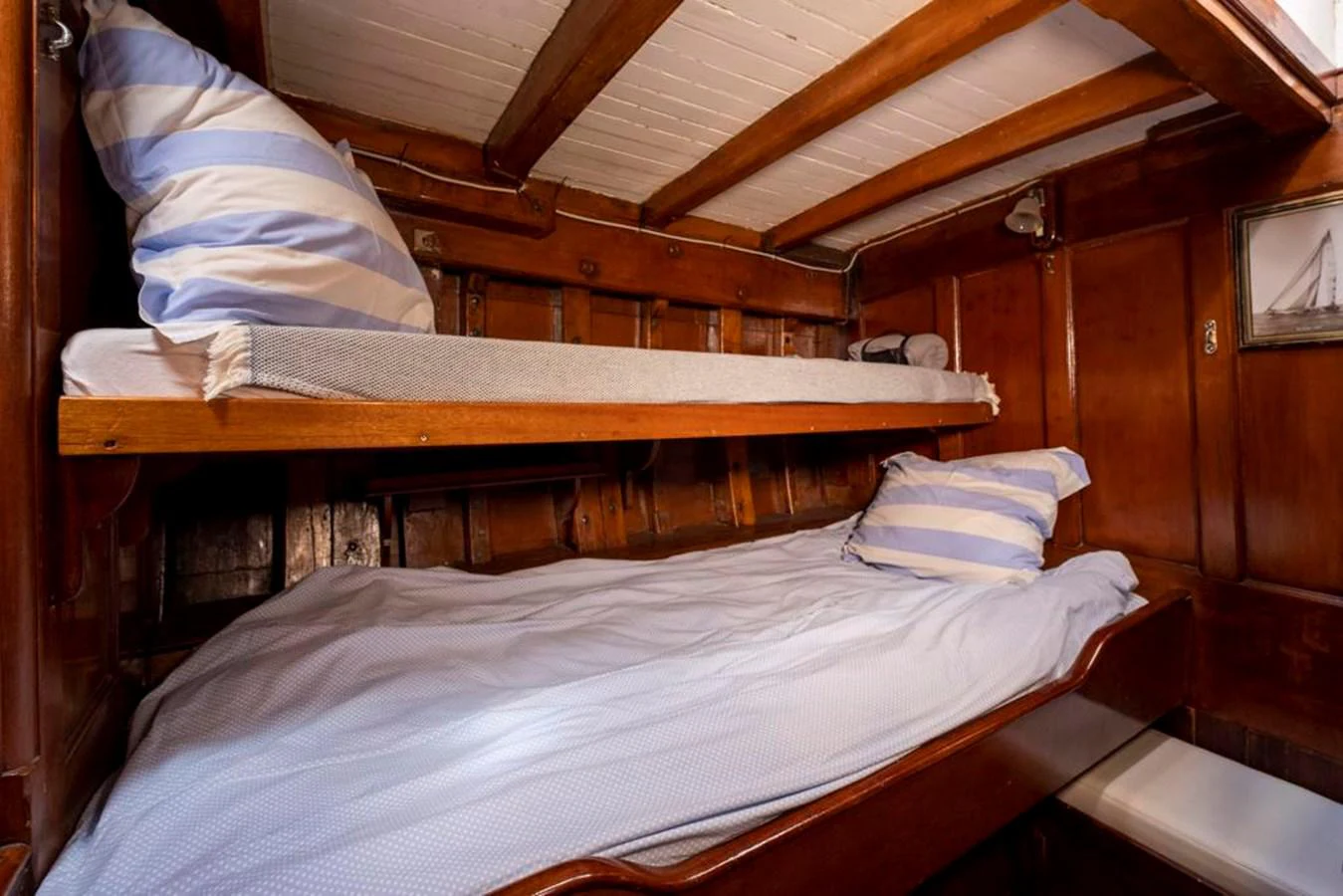 a bed with white sheets aboard JULIETTE Yacht for Sale