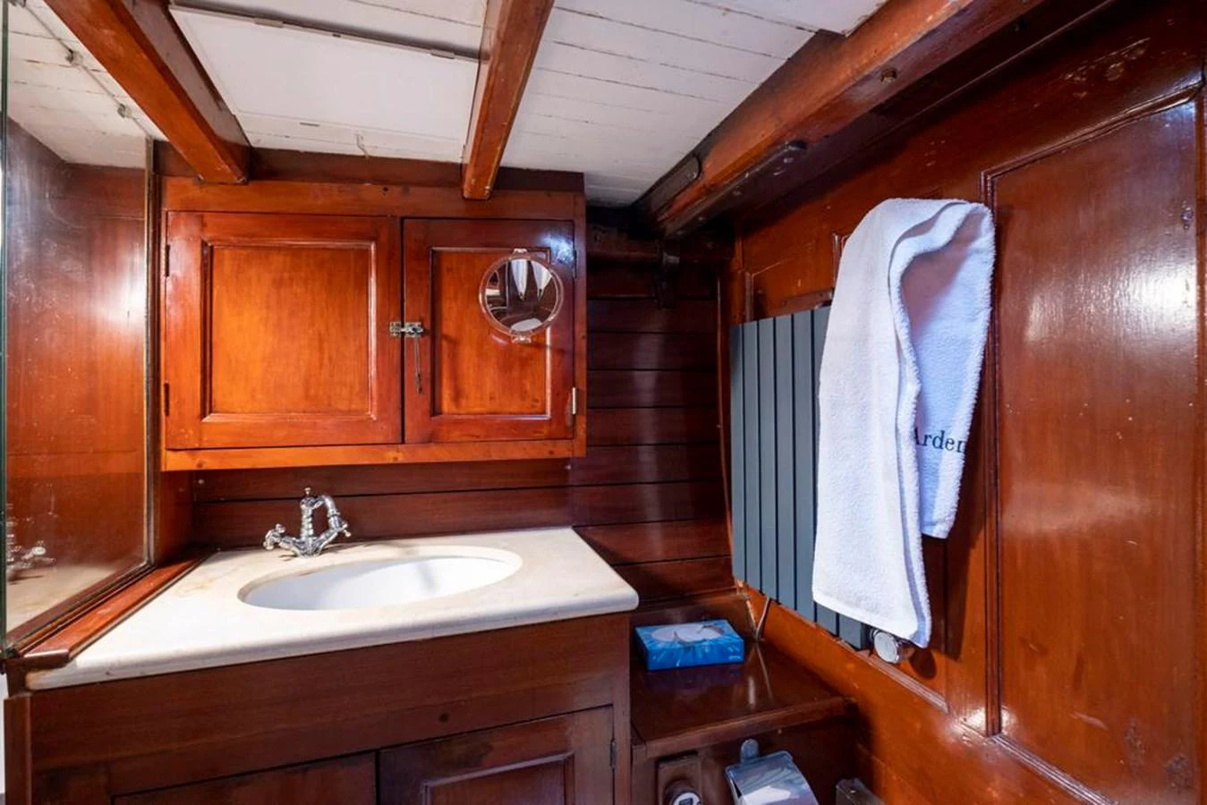 a bathroom with wooden cabinets aboard JULIETTE Yacht for Sale