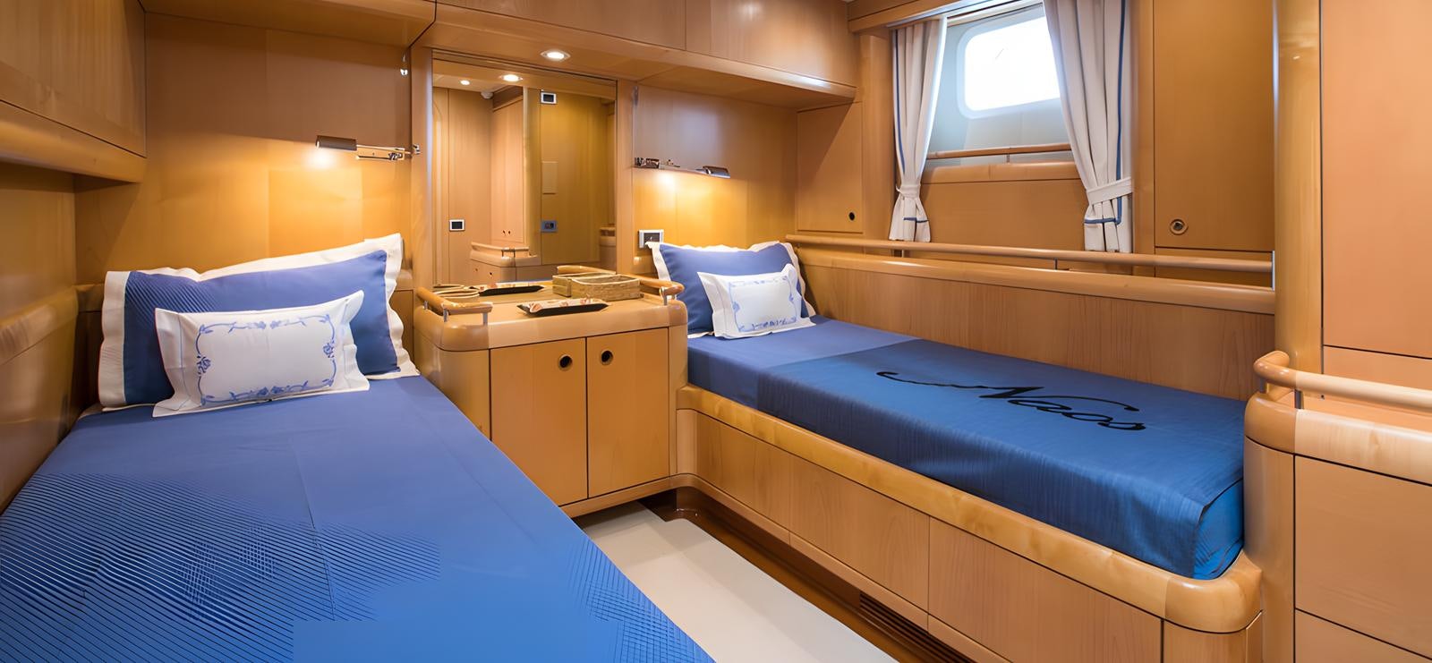 a room with two beds aboard NAOS Yacht for Sale