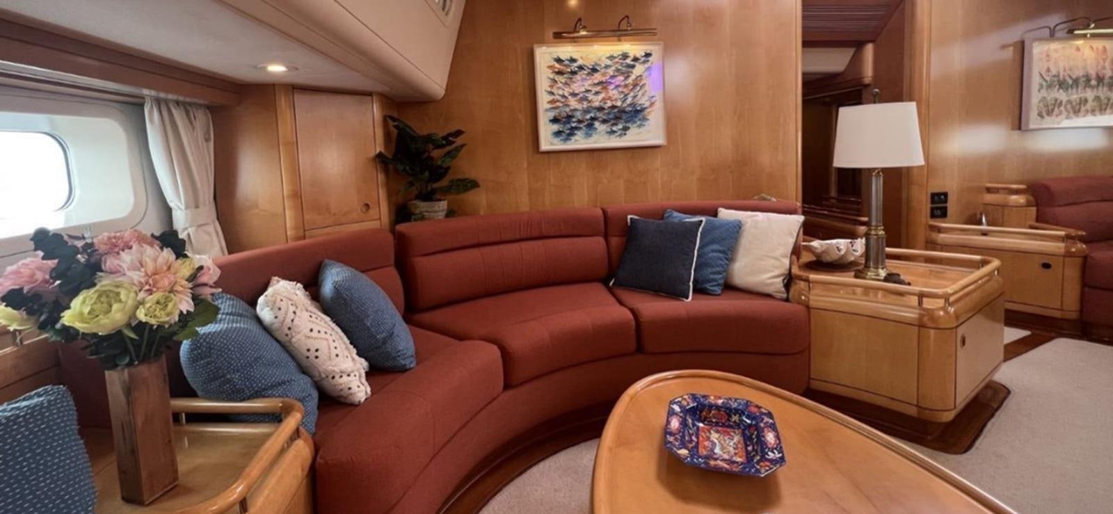 a living room with a couch and a table aboard NAOS Yacht for Sale