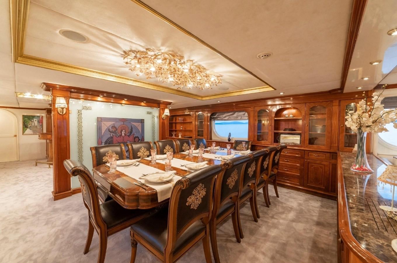 a dining room with a chandelier aboard ALKONOST Yacht for Sale