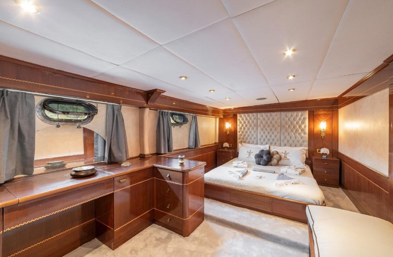 a room with a bed and a desk aboard ALKONOST Yacht for Sale