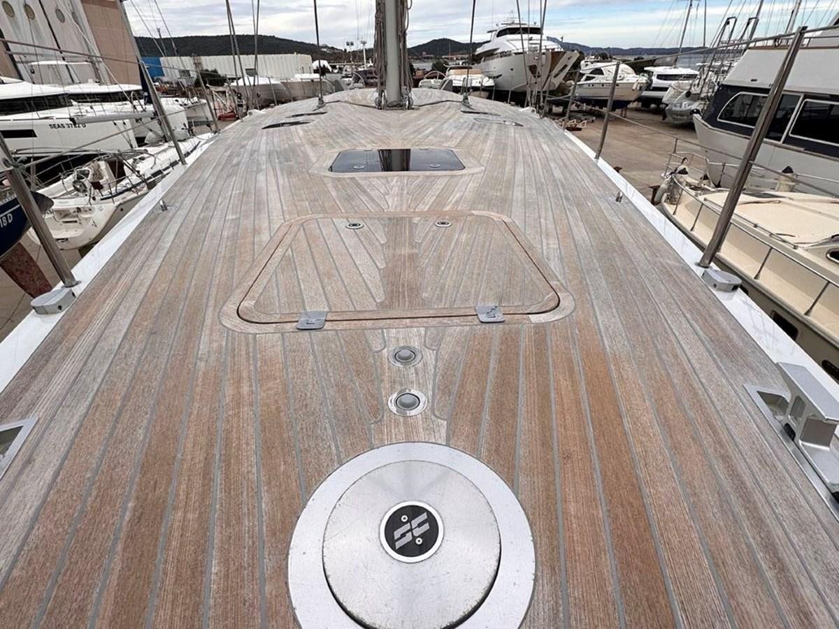 a large wooden deck aboard KARMA Yacht for Sale