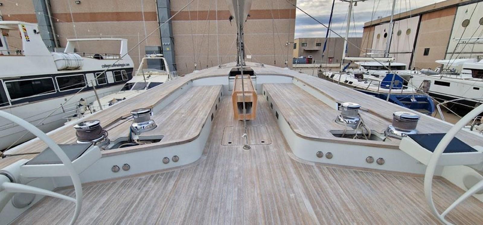 a wooden deck with white boats aboard KARMA Yacht for Sale
