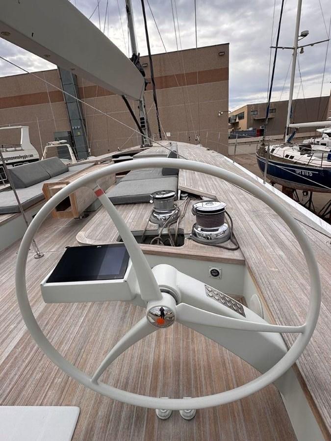 a white boat on a deck aboard KARMA Yacht for Sale
