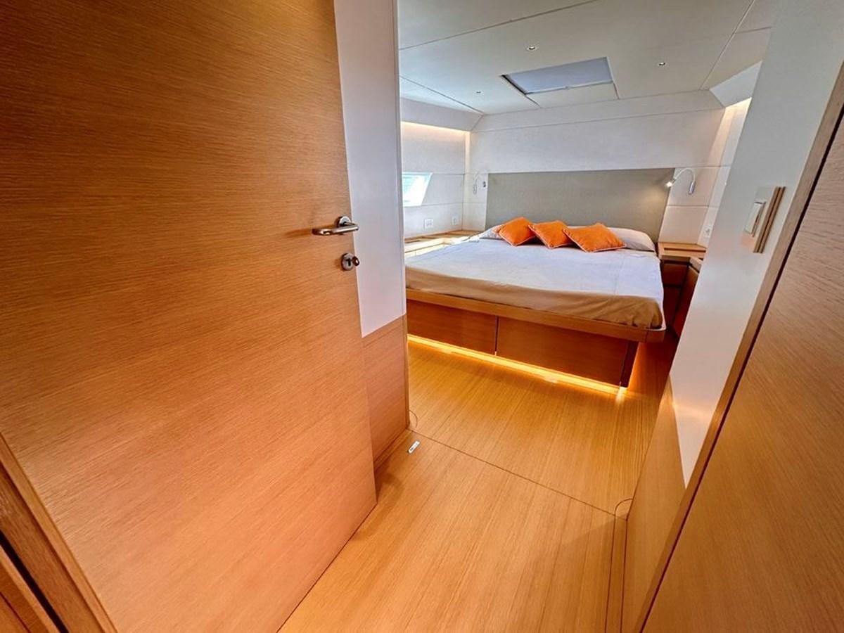 a room with a bed and a door aboard KARMA Yacht for Sale