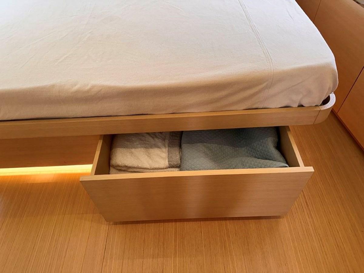 a bed with white sheets aboard KARMA Yacht for Sale