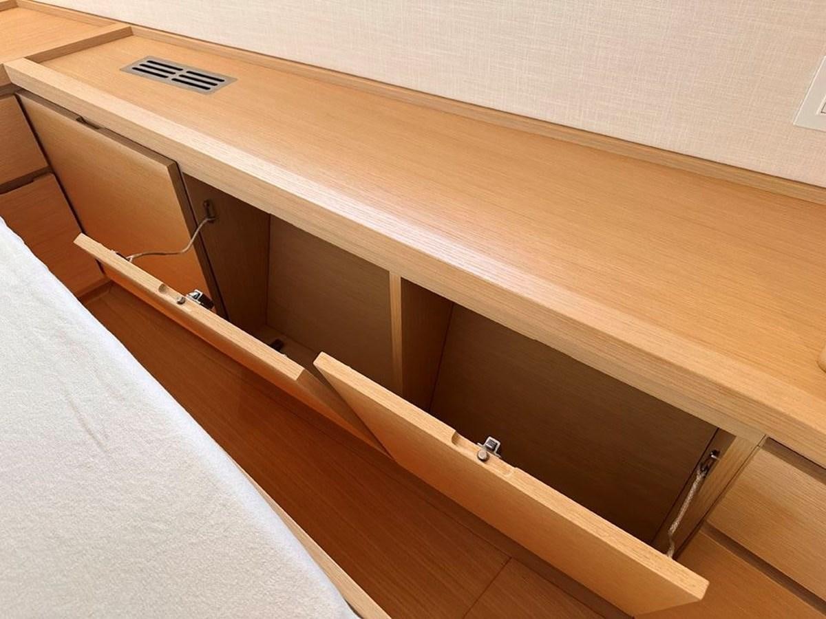 a wooden shelf with a white object on it aboard KARMA Yacht for Sale
