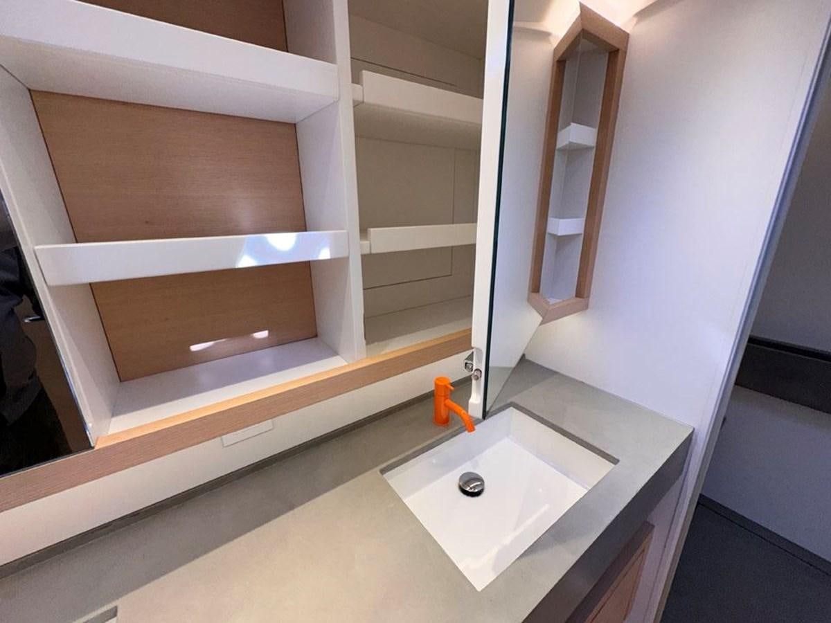 a bathroom with a sink and a mirror aboard KARMA Yacht for Sale