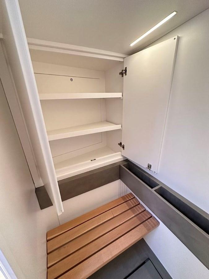 a white cabinet with a light on it aboard KARMA Yacht for Sale