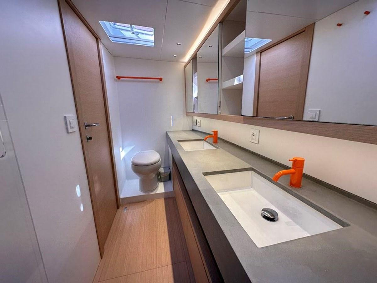 a bathroom with a sink and a toilet aboard KARMA Yacht for Sale